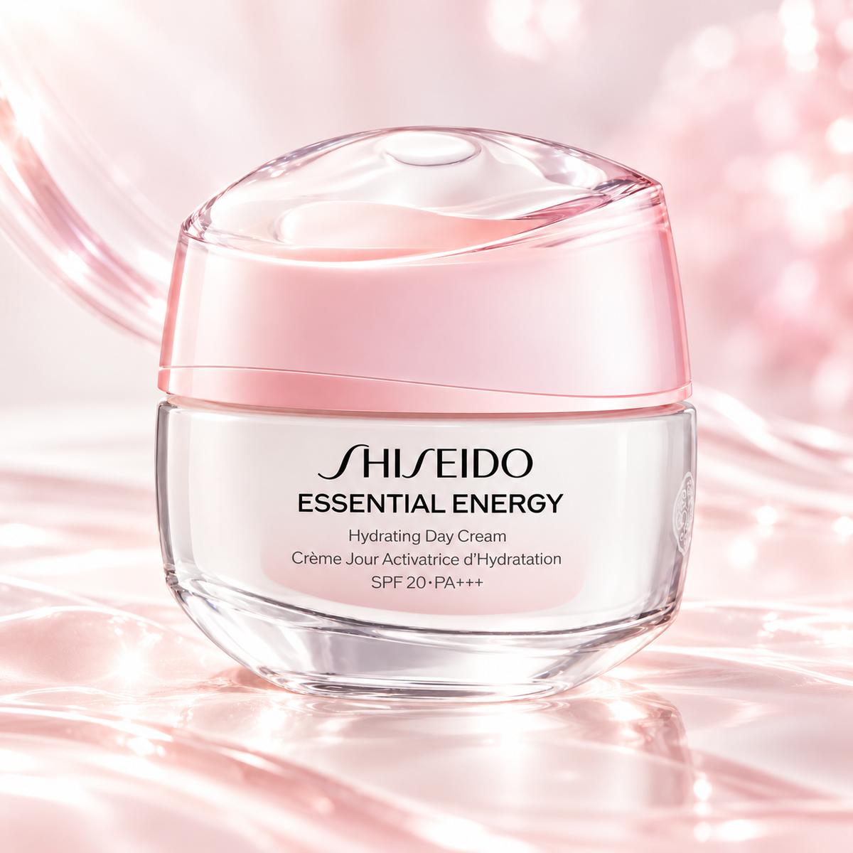 Shiseido Essential Energy Hydrating Day Cream SPF 20 PA+++ in a luxurious white jar with a delicate pink translucent lid, displayed on a glossy blush-pink surface with flowing silky textures, soft reflections and luminous highlights. Elegant Japanese skincare in a radiant, feminine setting.