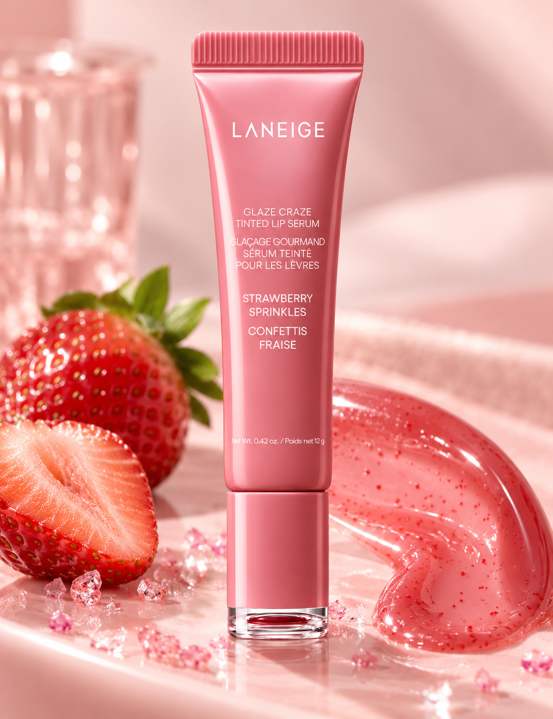 LANEIGE Glaze Craze Tinted Lip Serum Strawberry Sprinkles 12g displayed with fresh strawberries, sparkling pink accents and glossy strawberry-tinted serum texture.