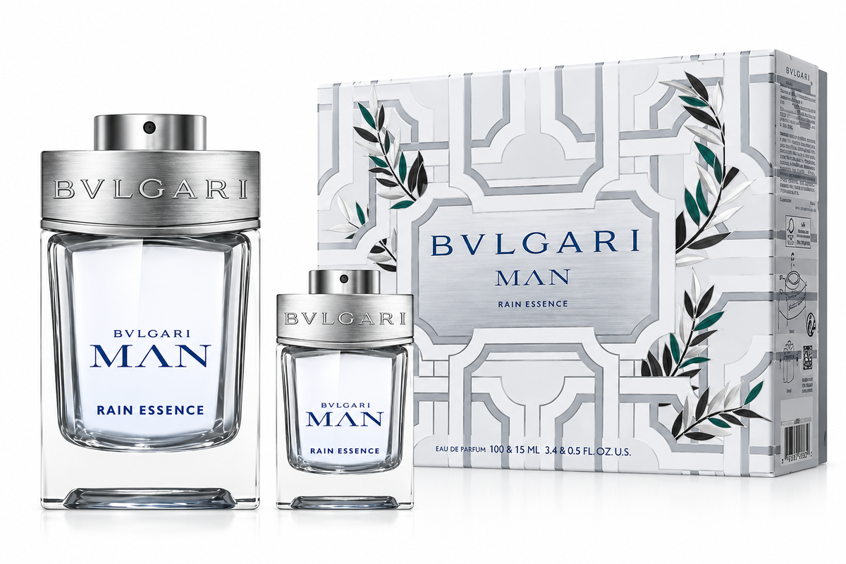 Bvlgari Man Rain Essence perfume gift set for men, featuring two transparent fragrance bottles in different sizes with silver caps and blue lettering, alongside an elegant white Bvlgari gift box decorated with geometric patterns and botanical details. Fresh, sophisticated men's fragrance set.