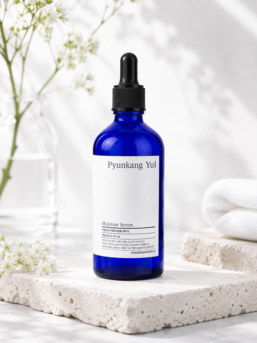 Pyunkang Yul Moisture Serum 100ml on a white surface with a clean and aesthetic background.
