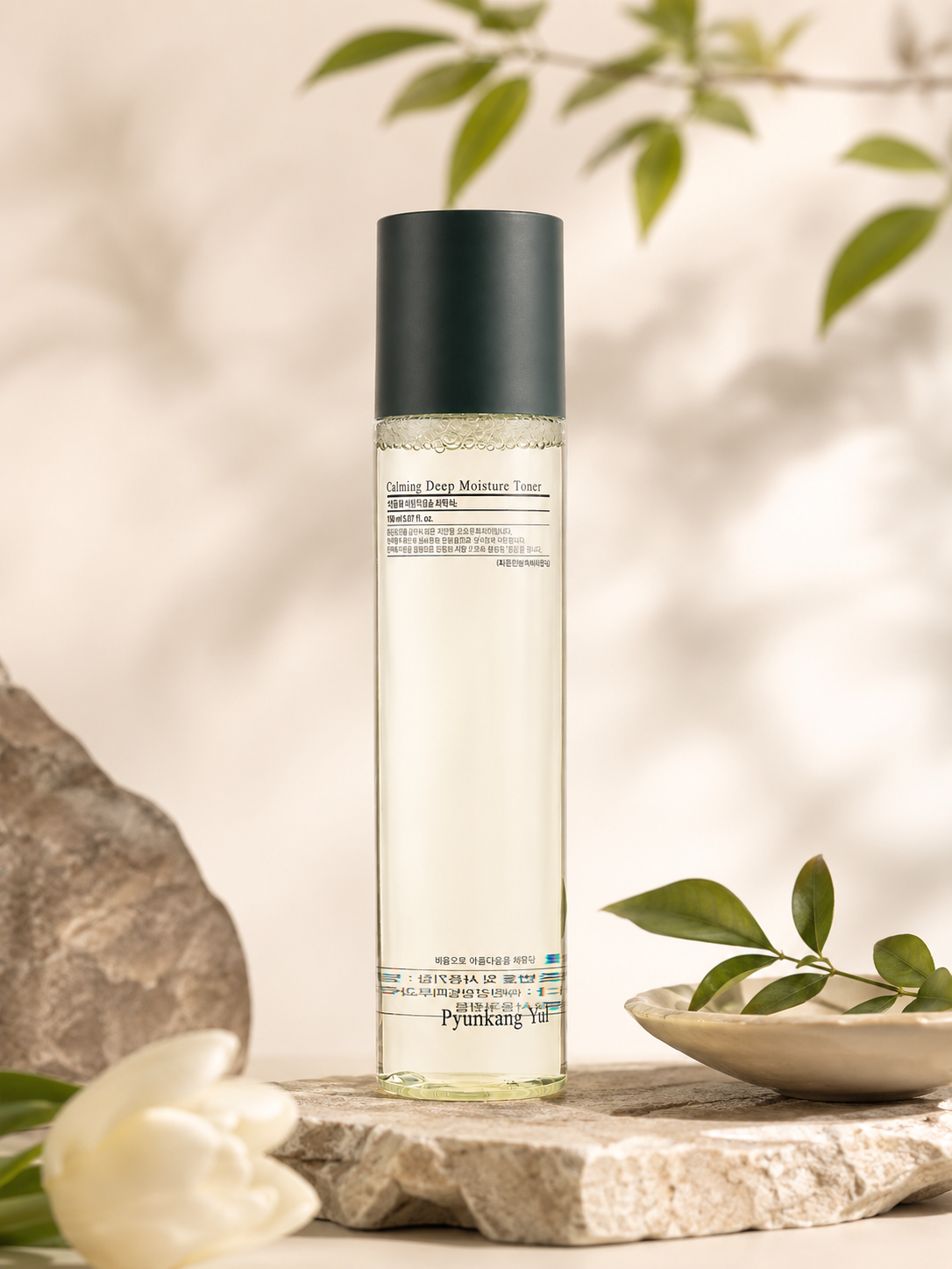 Pyunkang Yul Calming Deep Moisture Toner 150ml with green leaves and stone background