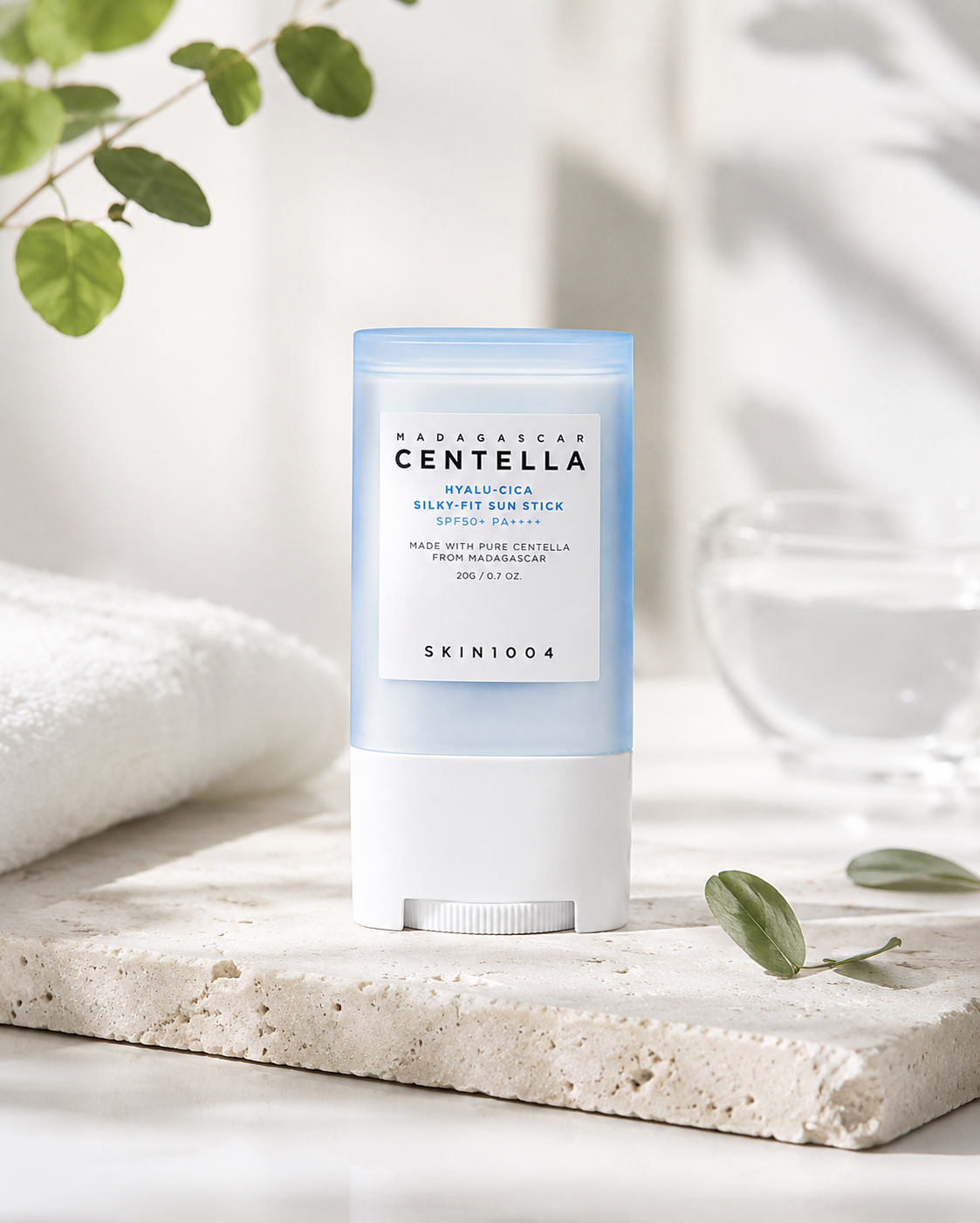 SKIN1004 Madagascar Centella Hyalu-Cica Silky-fit Sun Stick 20g on a neutral background with decorative elements
