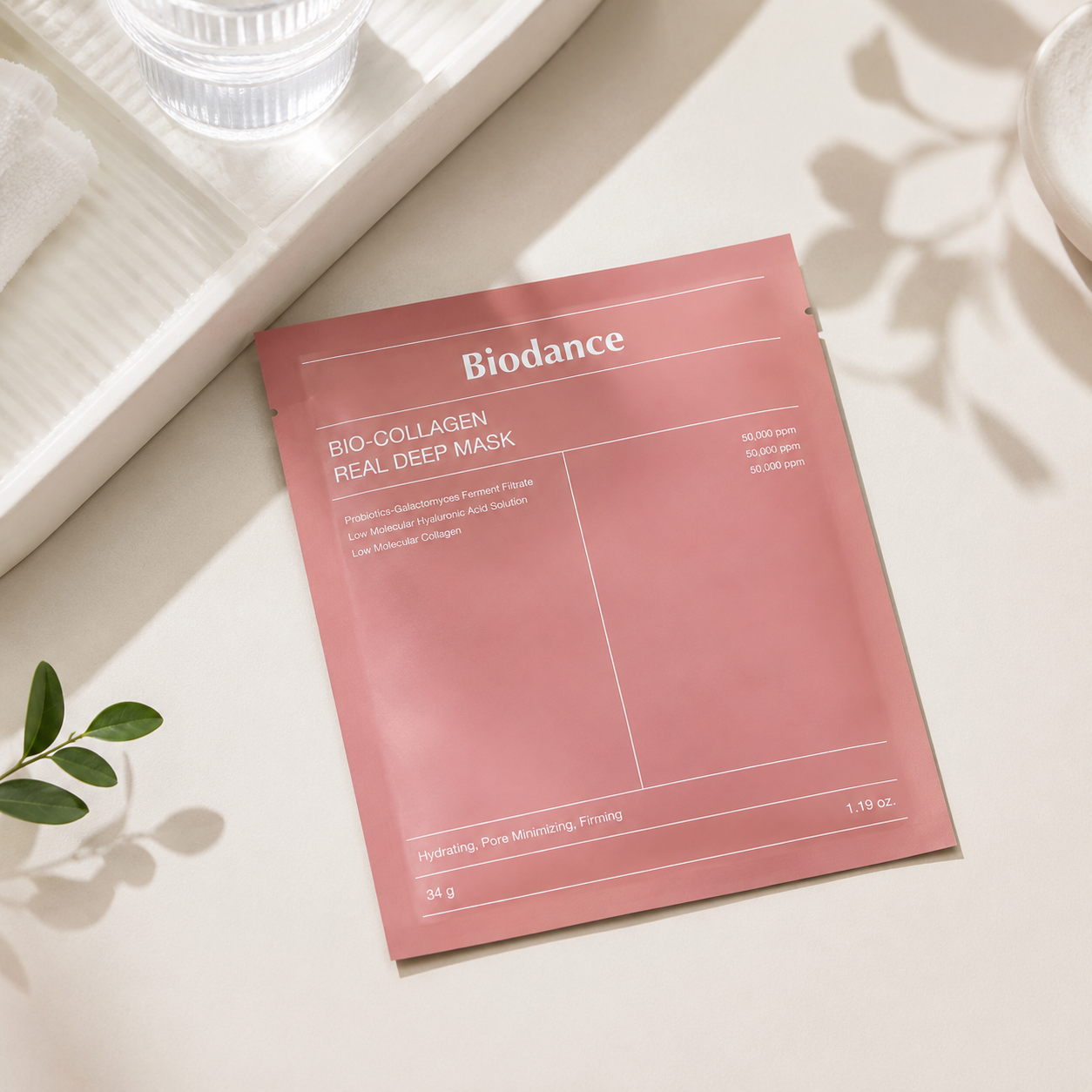 Biodance Bio Collagen Real Deep Mask elegantly displayed in a bright minimalist skincare setting with soft natural daylight, a premium facial mask sachet resting on a clean stone surface beside glass accents, fresh botanical elements and spa-inspired décor, highlighting its luxurious collagen-rich hydrogel formula, intense hydration and refined Korean skincare aesthetic for glowing, healthy-looking skin.
